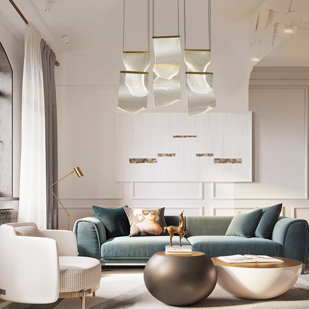 Acrylic ribbon chandelier lighting a modern staircase area