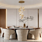 Acrylic ribbon chandelier above a luxurious dining table