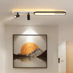 Adjustable ceiling spotlights aimed at framed wall art