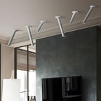 Adjustable surface spotlight aimed at a dark accent wall