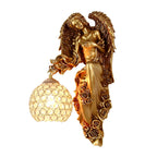 Side view of the angel figure holding the crystal globe