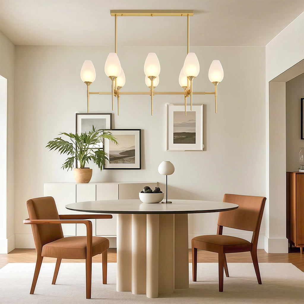Glass chandelier above a round modern dining table