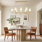Glass chandelier above a round modern dining table