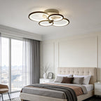 Multi ring ceiling light glowing warm in a bedroom