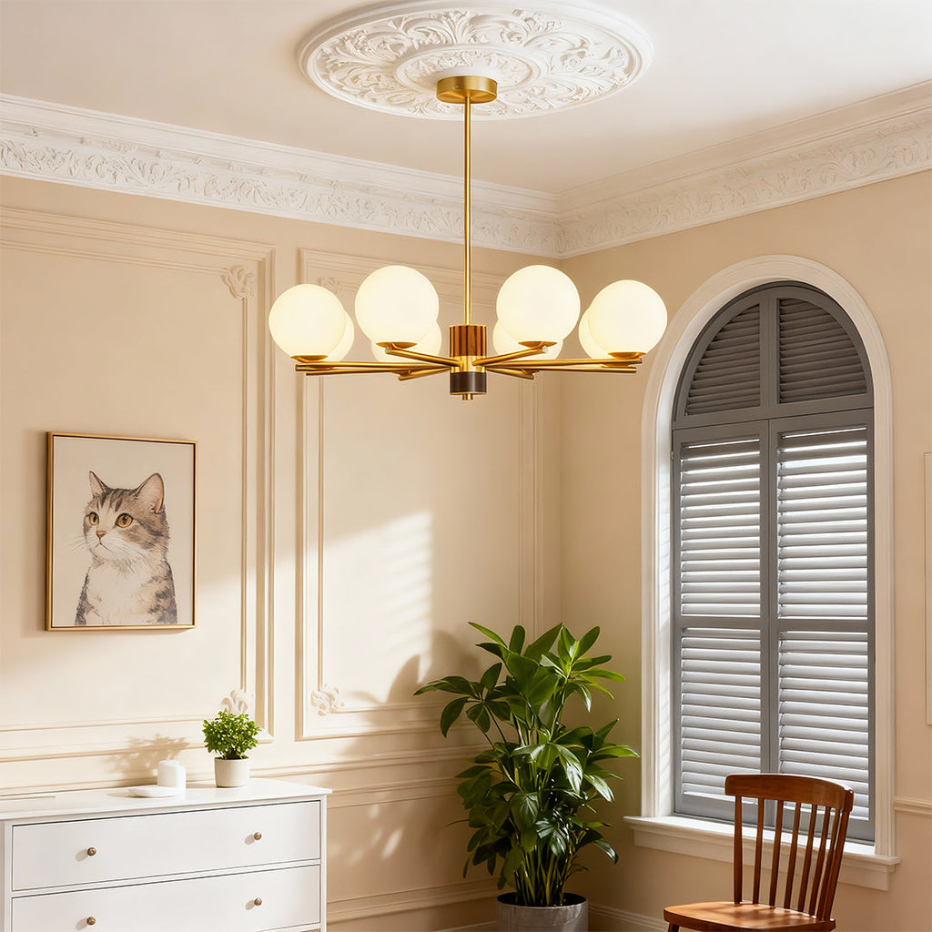Sculptural chandelier in a bright living room with an arched mirror
