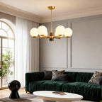 Sculptural chandelier in an interior with green velvet seating