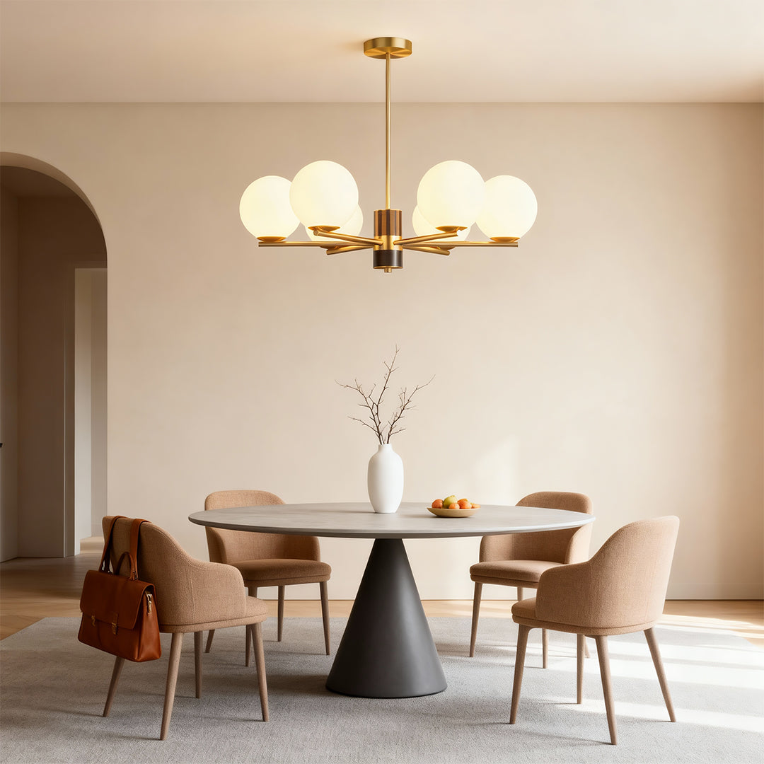 Sculptural chandelier above a round table in a minimalist dining room