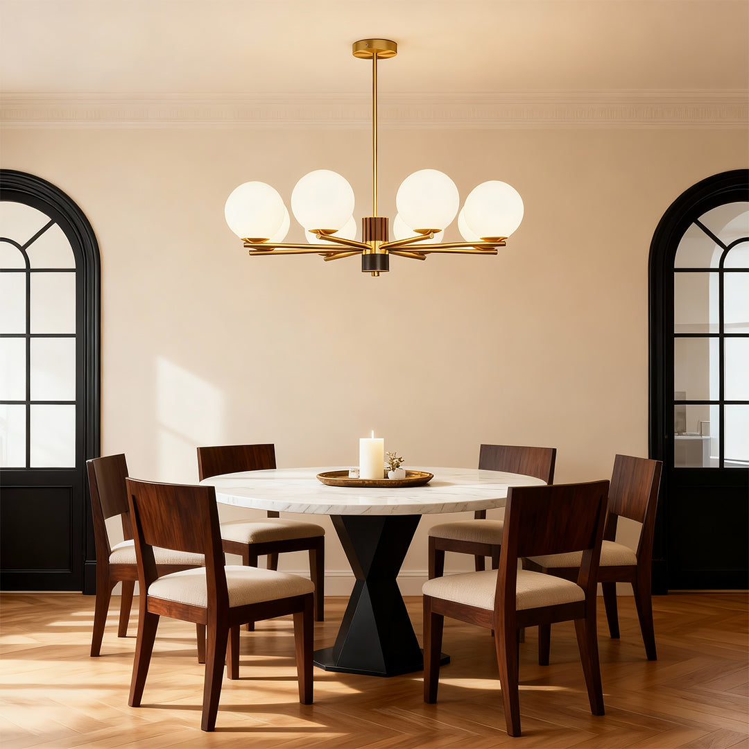 Sculptural chandelier in a warm dining room with arched windows