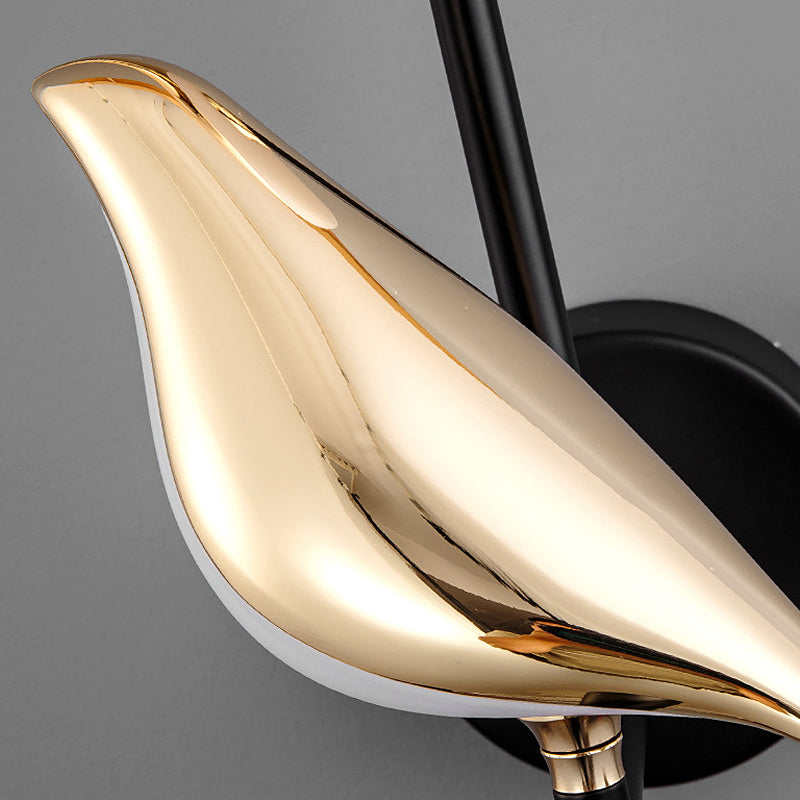 Close-up of the black metal bird figure on the sconce