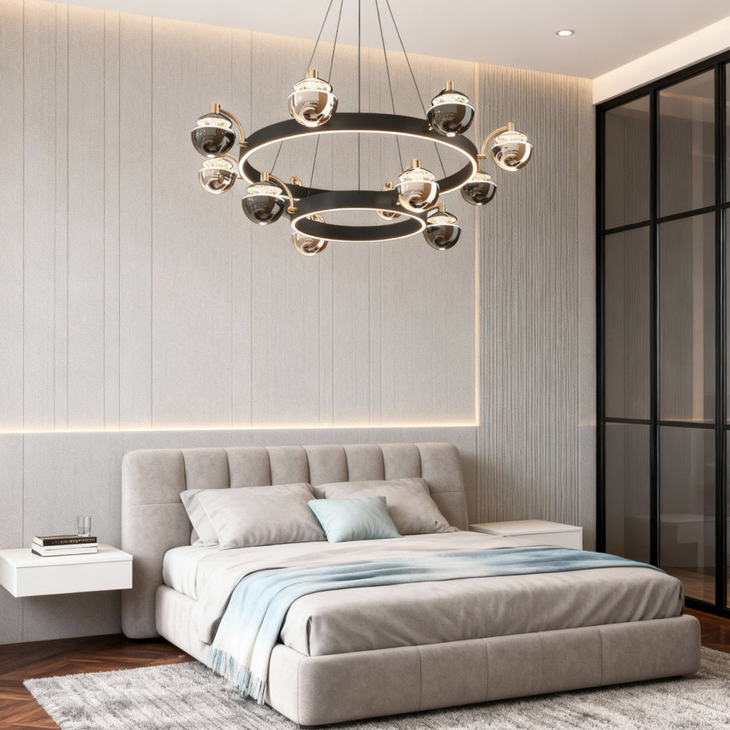 Black and gold chandelier in a bedroom with a tufted bed