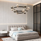 Black and gold chandelier in a bedroom with a tufted bed