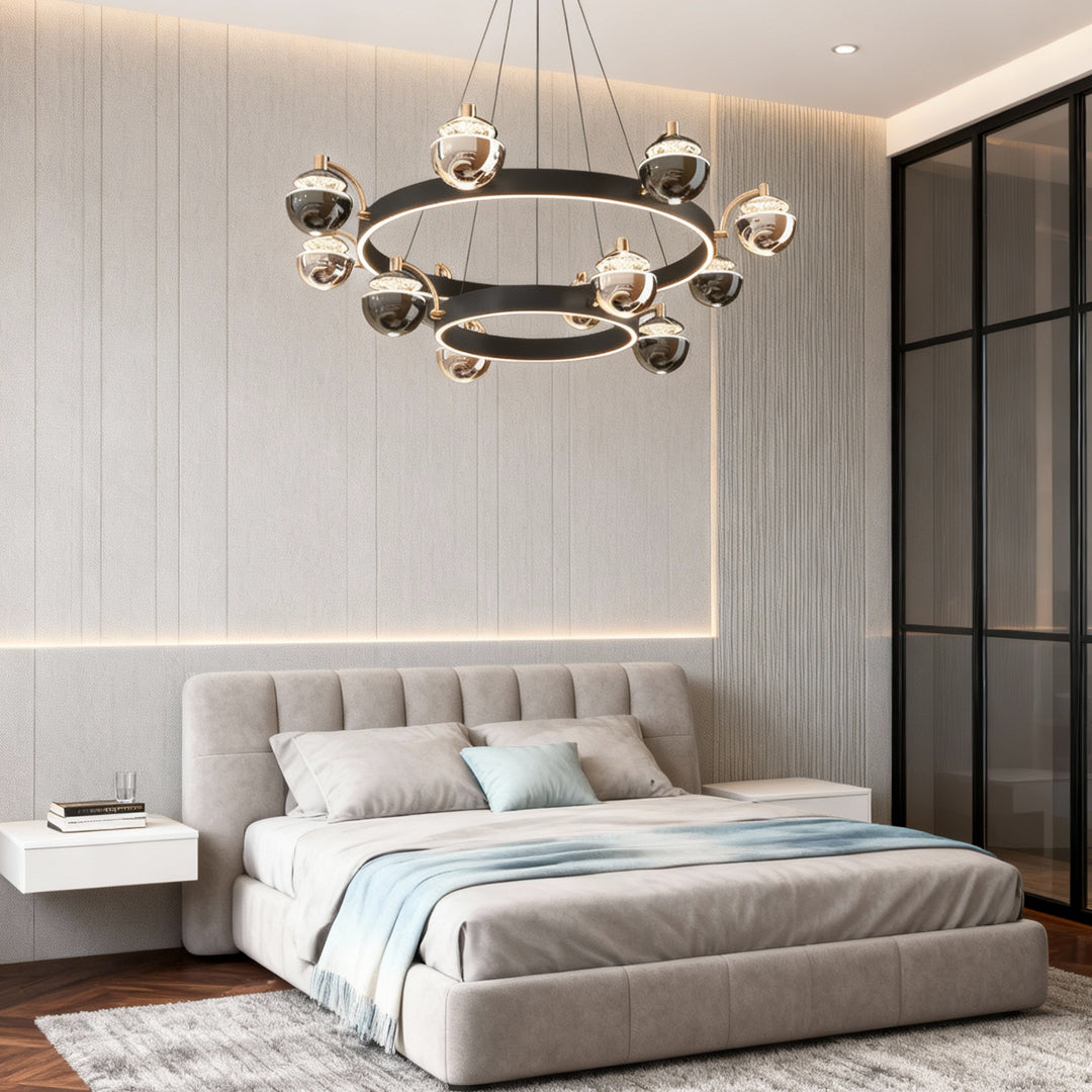 Black and gold chandelier in a bedroom with a tufted bed