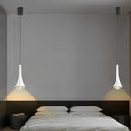 Black cone pendant light installed beside a bed