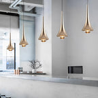 Metallic cone pendant lights above a dining table