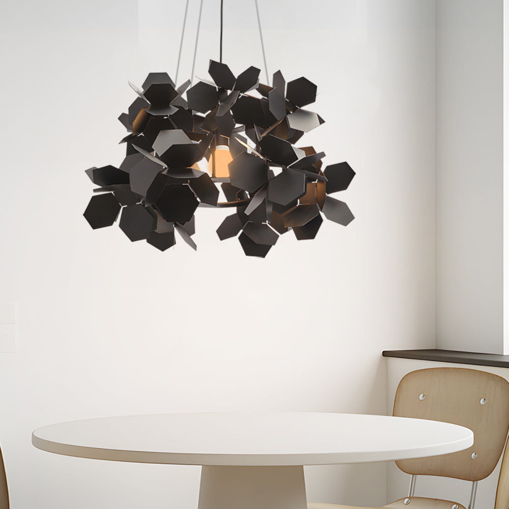 Black leaf chandelier above a minimalist dining table