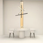 Black iron linear chandelier above a round white dining table
