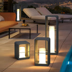 Black lantern lighting a contemporary outdoor seating area at night