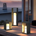 Black geometric frame lantern on a wooden pool deck at dusk