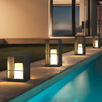 Sleek black lantern giving ambient light beside an infinity pool