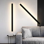 Black linear sconce giving ambient light in a contemporary interior