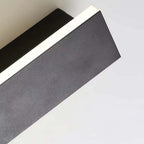 Close-up of the illuminated linear structure of the sconce