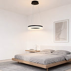 Black ring pendant light hanging in a bedroom