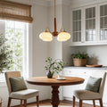 Walnut and brass chandelier giving warm light in a classic dining room