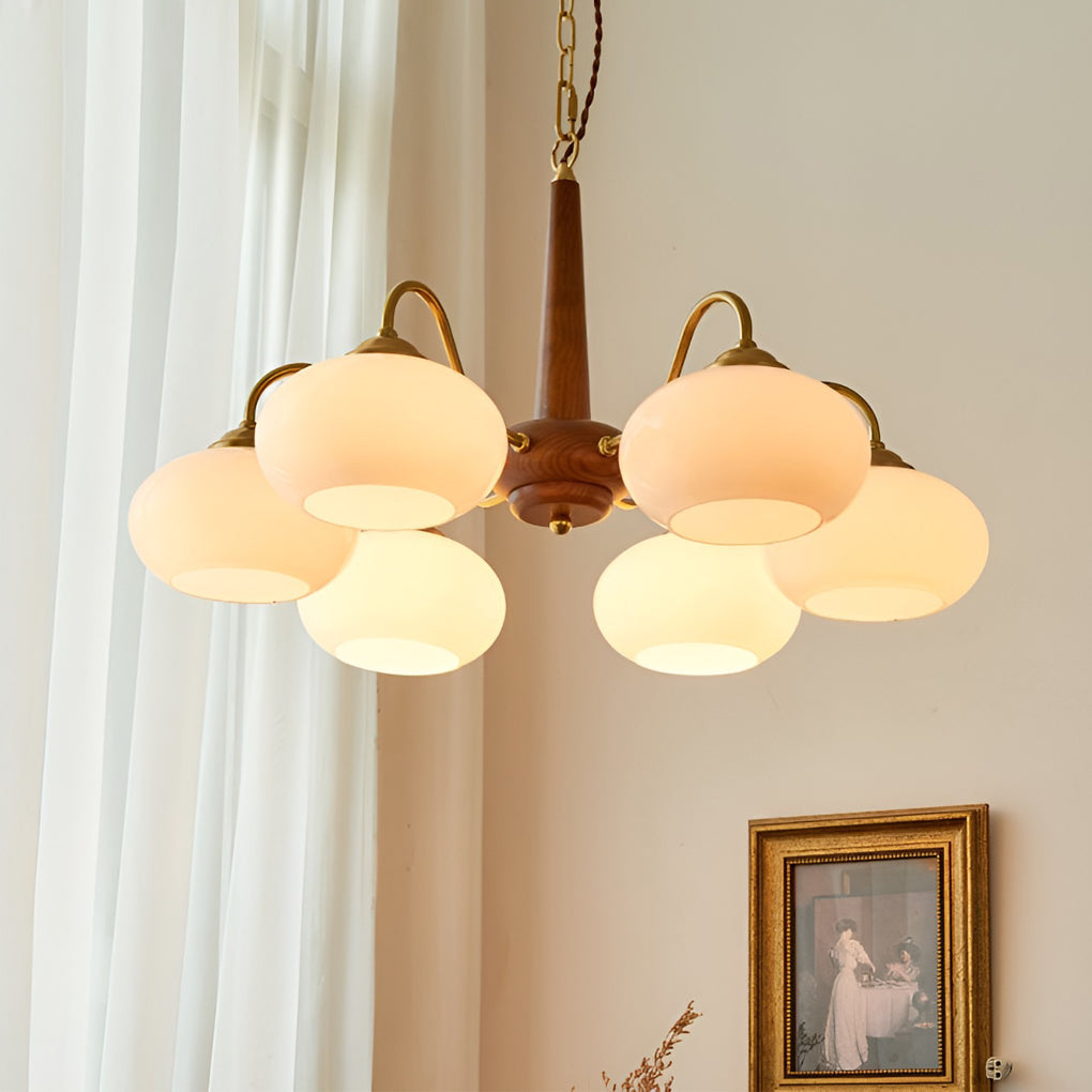 Walnut and brass chandelier above a cozy reading nook