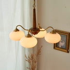 Walnut and brass chandelier above a modern dining table