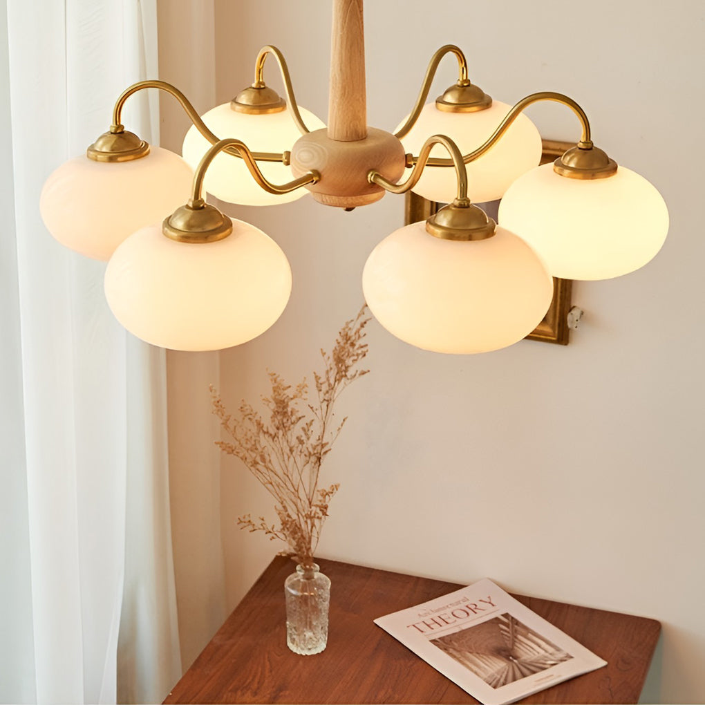 Walnut and brass chandelier softly lighting a stylish kitchen