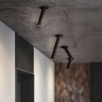 Black and white surface spotlights on a concrete ceiling