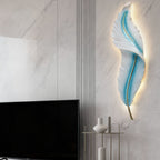 Blue feather wall light on a marble wall above the television