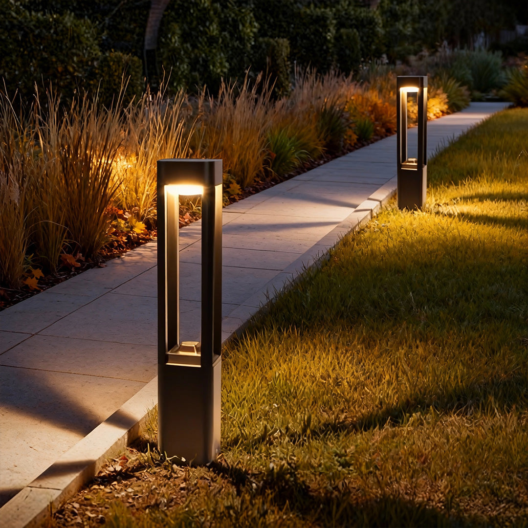 Bollard lights along a curved walkway at night
