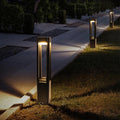 Bollard path lights installed along a straight garden path