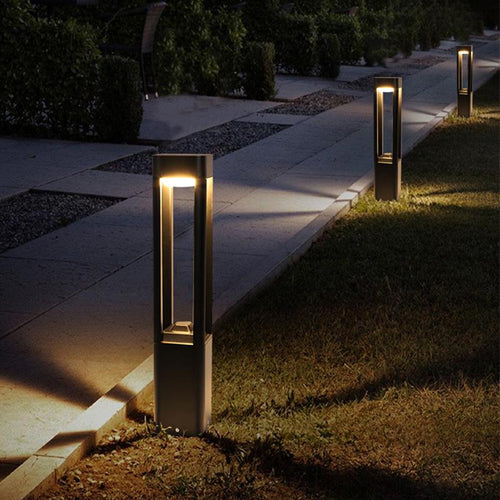 Bollard path lights installed along a straight garden path