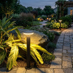 Contemporary bollard light set into a landscaped bed