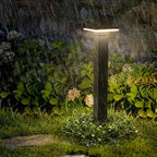 Bollard pathway lights lining a walkway beside a driveway