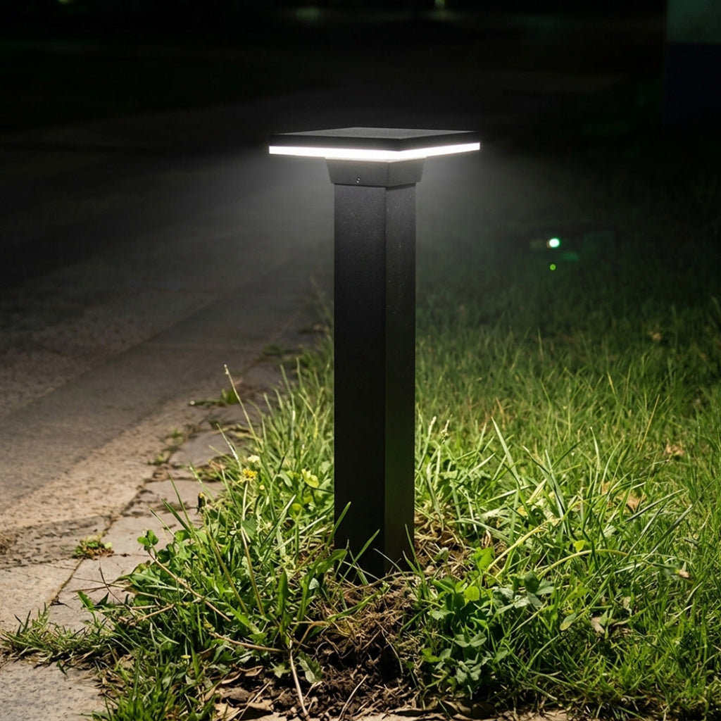 Steel bollard light beside a planted garden pathway