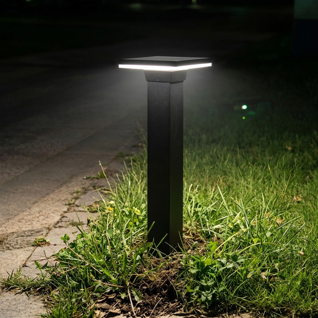Steel bollard light beside a planted garden pathway