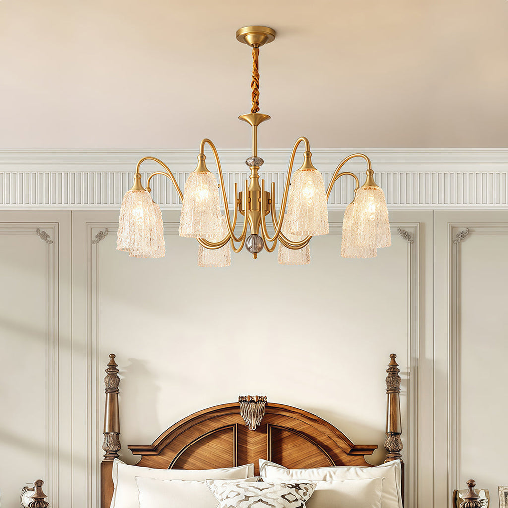 Vintage brass chandelier giving warm light in a luxurious bedroom