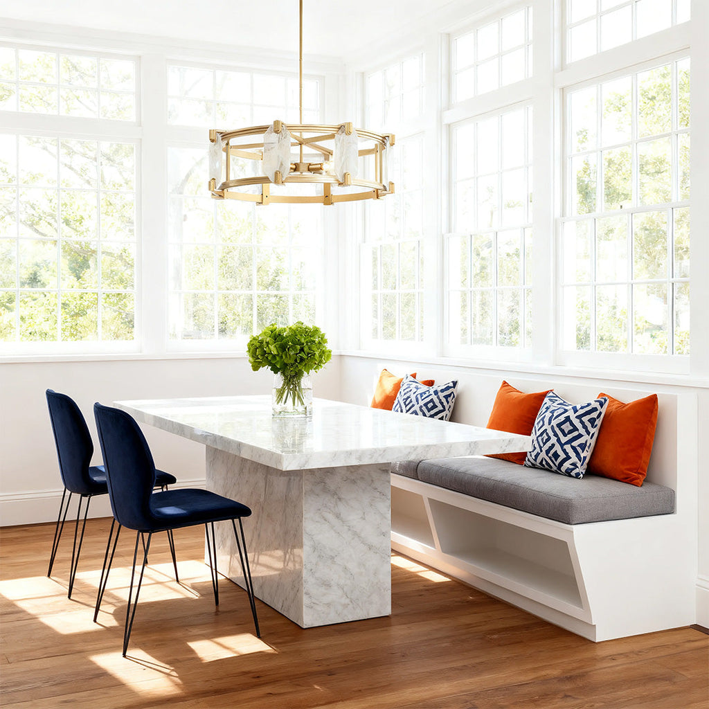 Round glass chandelier in a bright sunroom with marble bench