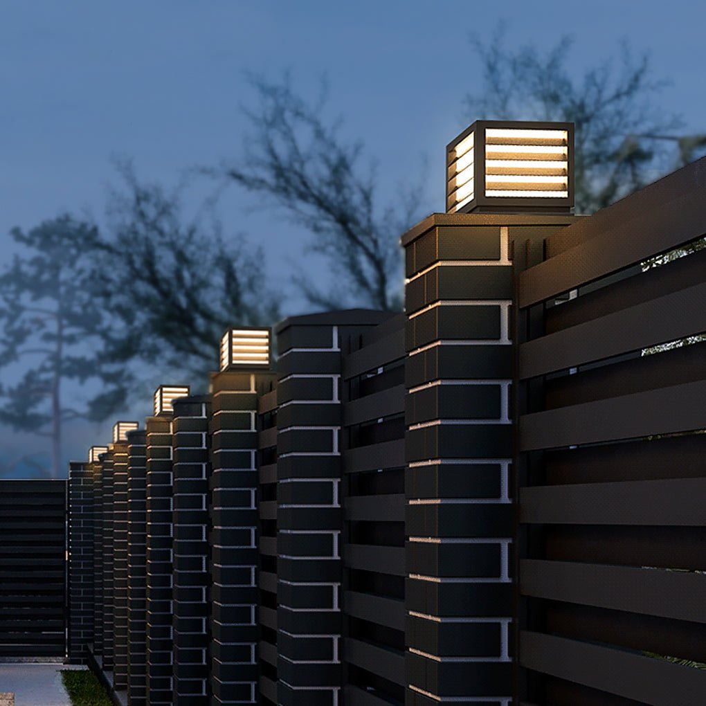 LED pillar post lamp standing beside a garden pathway