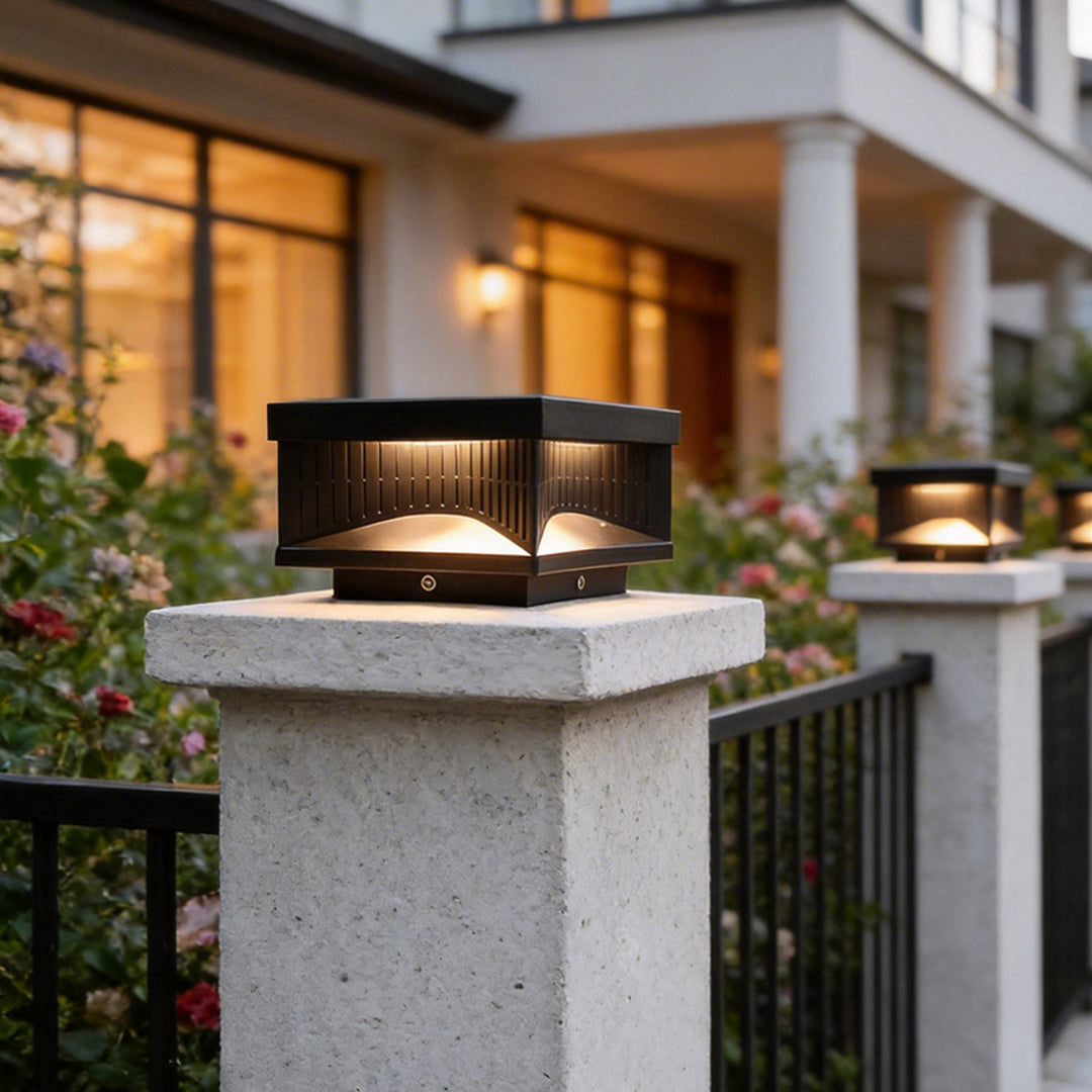 Square pillar light beside a garden pathway at night
