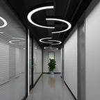 C-shaped pendant lights hanging in a contemporary hallway