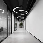 C-shaped arc pendant light in a minimalist corridor