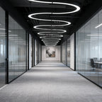 C-shaped pendant lights suspended in an office hallway