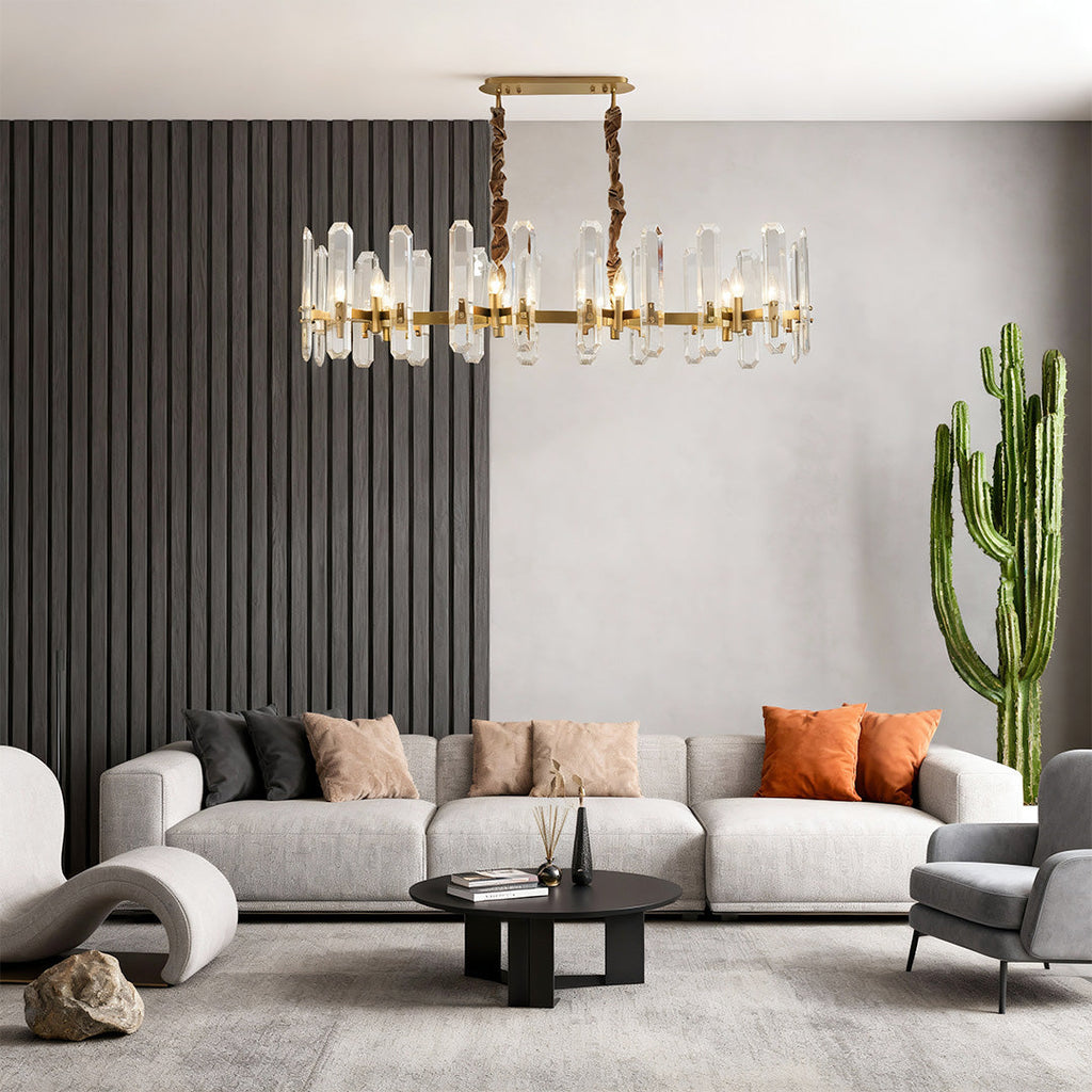 Brass ring chandelier hanging above a grey sectional sofa