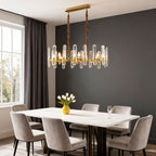 Brass ring chandelier above a modern marble dining table