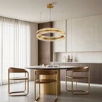 Gold finish circular chandelier over a round dining table