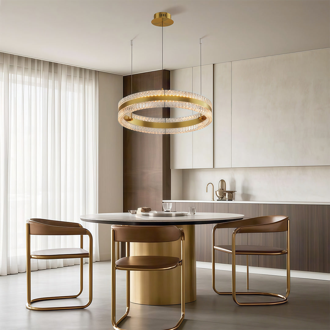 Gold finish circular chandelier over a round dining table